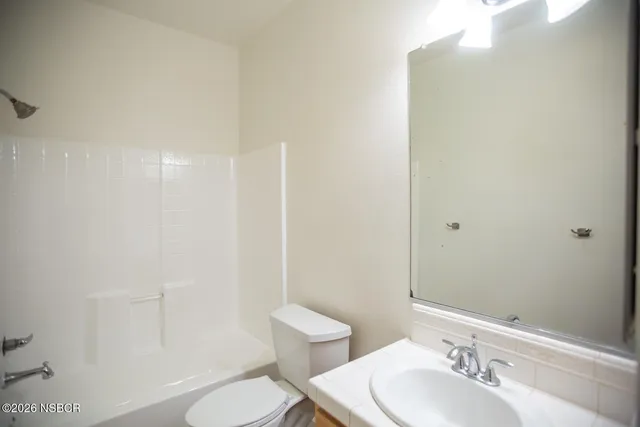 a view of a room that has wooden floor and a window