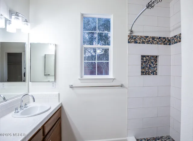 a bathroom with a sink a toilet and window