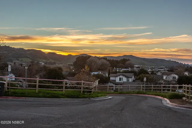 a view of a street with a yard in back