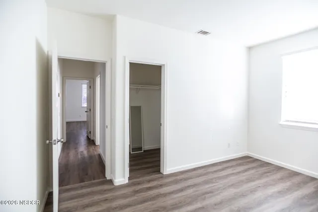 a view of a backyard with barn and wooden fence