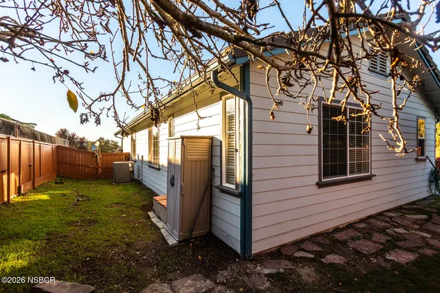a view of backyard with wooden fence