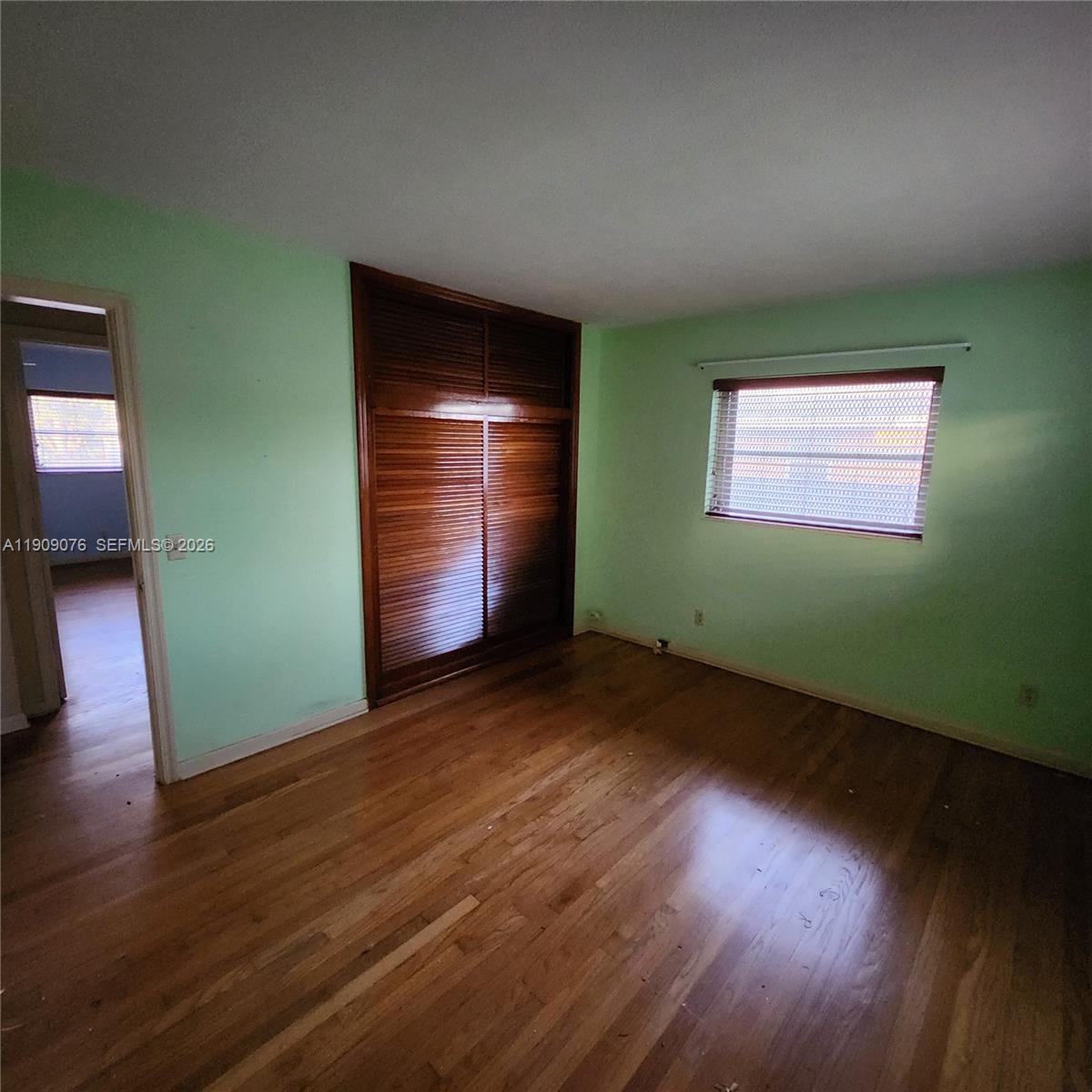 1547 West 10th Street Riviera Beach, FL 33404 - Photo 20 of 20 an empty room with wooden floor and windows