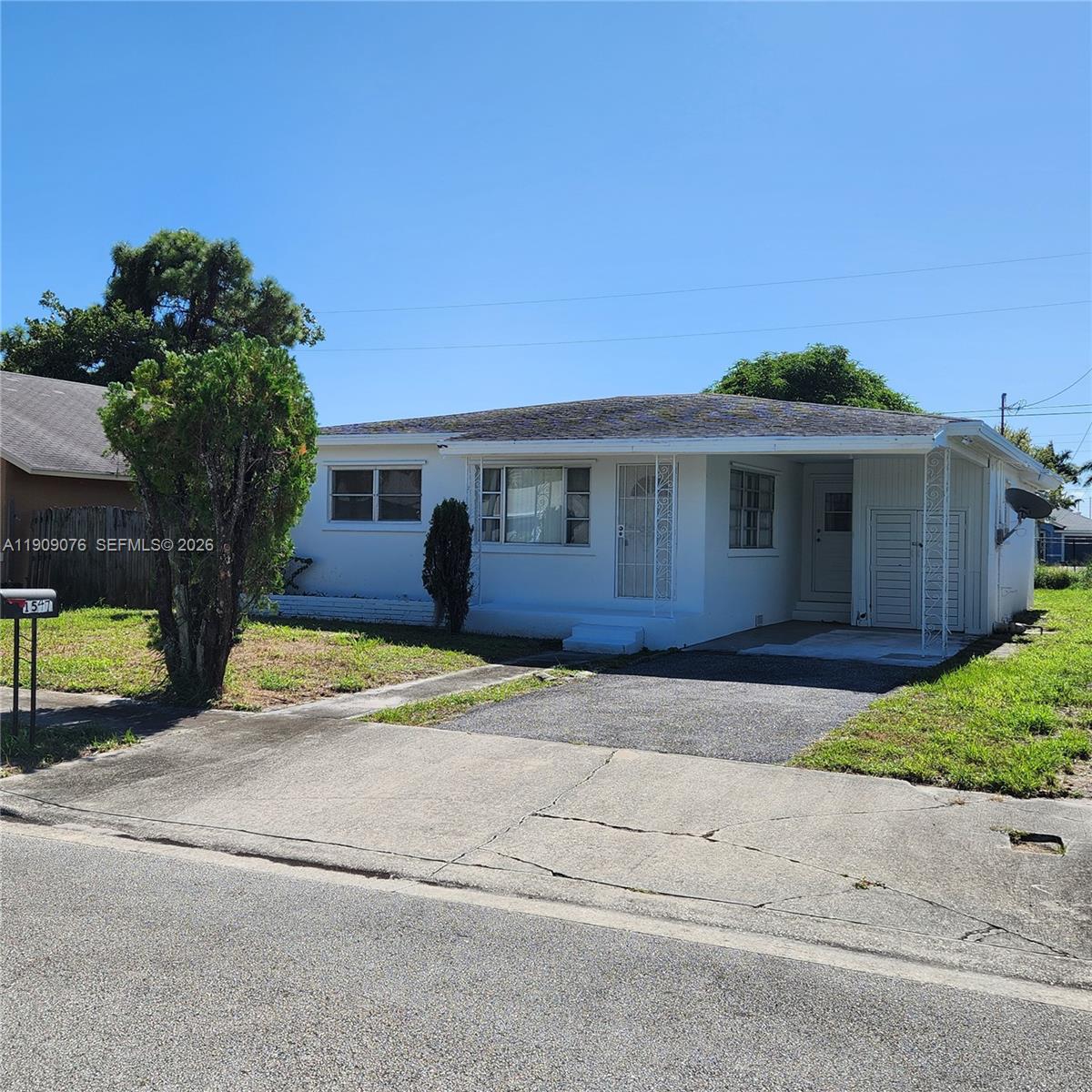 1547 West 10th Street Riviera Beach, FL 33404 - Photo 2 of 20 a front view of a house with a yard and garage