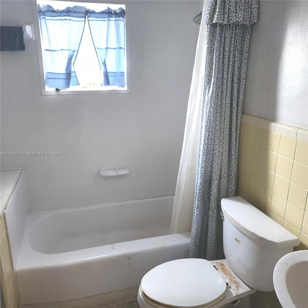 1547 West 10th Street Riviera Beach, FL 33404 - Photo 6 of 10 a white toilet sitting next to a bath tub