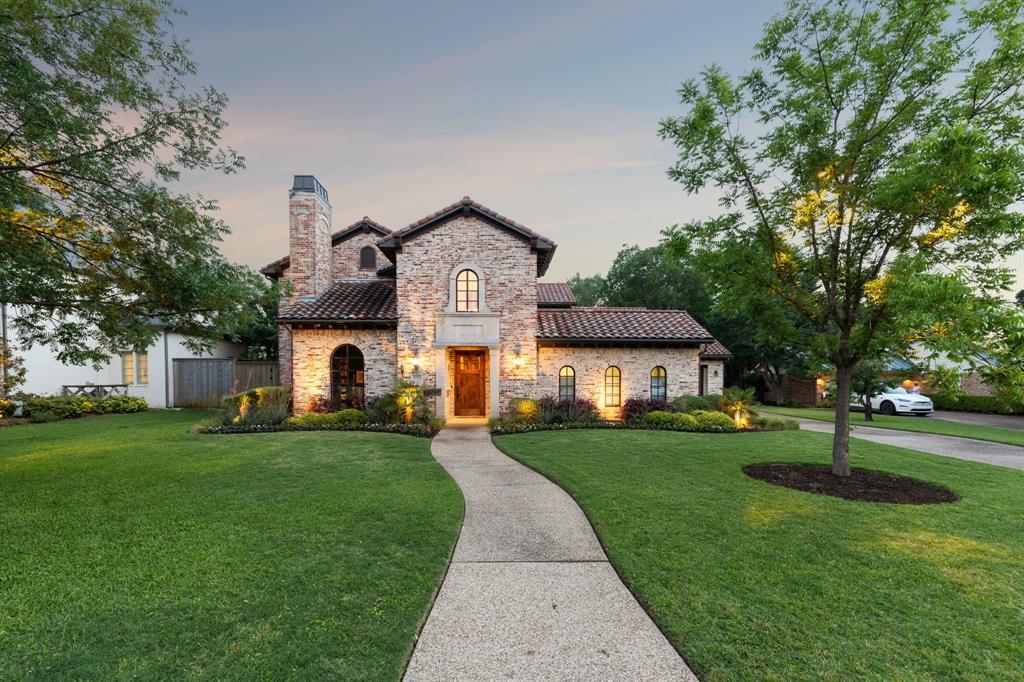 a front view of a house with a garden