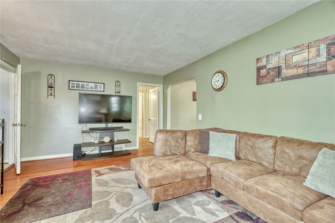 606 Bay Road Webster, NY 14580 - Photo 4 of 49 Family room with hardwood floors, wood burning fir