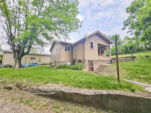 a house that has a tree in front of the house