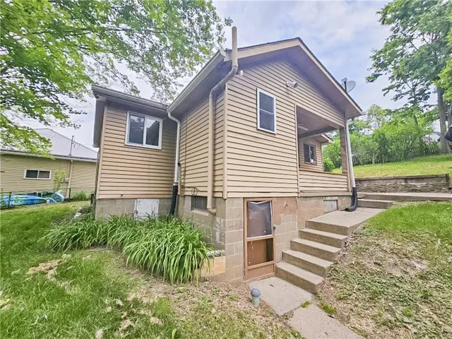 a view of a house with a yard and plants