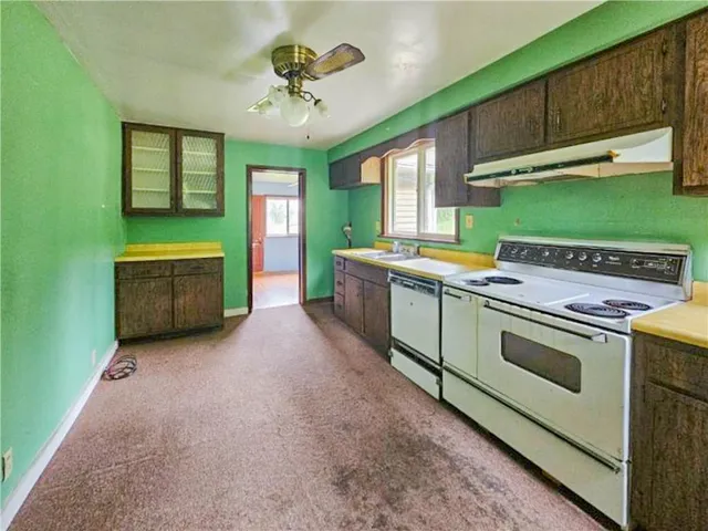 a kitchen with a stove and a microwave oven