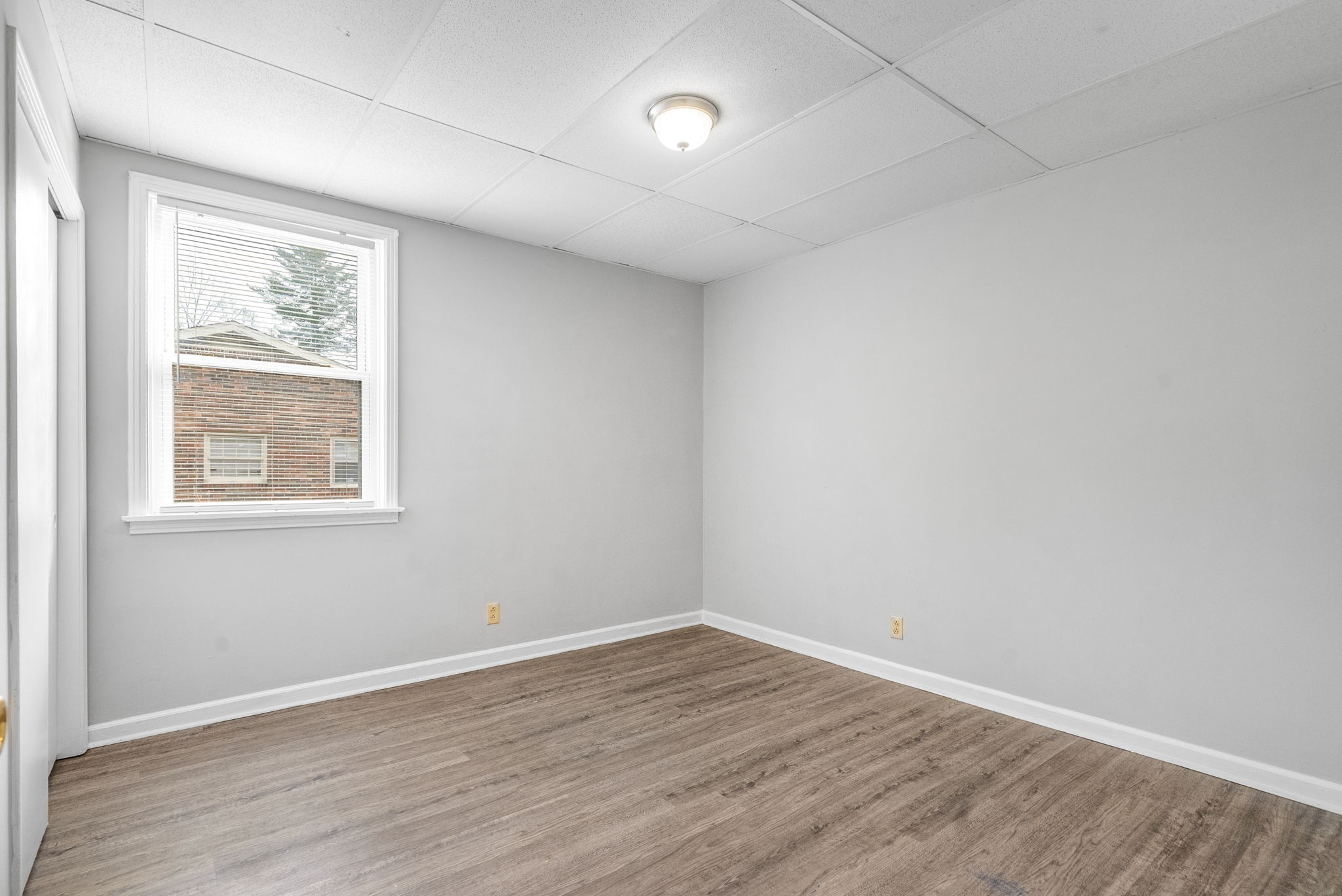 1600 Paradise Hill Road, Unit B Clarksville, TN 37043 - Photo 12 of 20 an empty room with wooden floor and windows