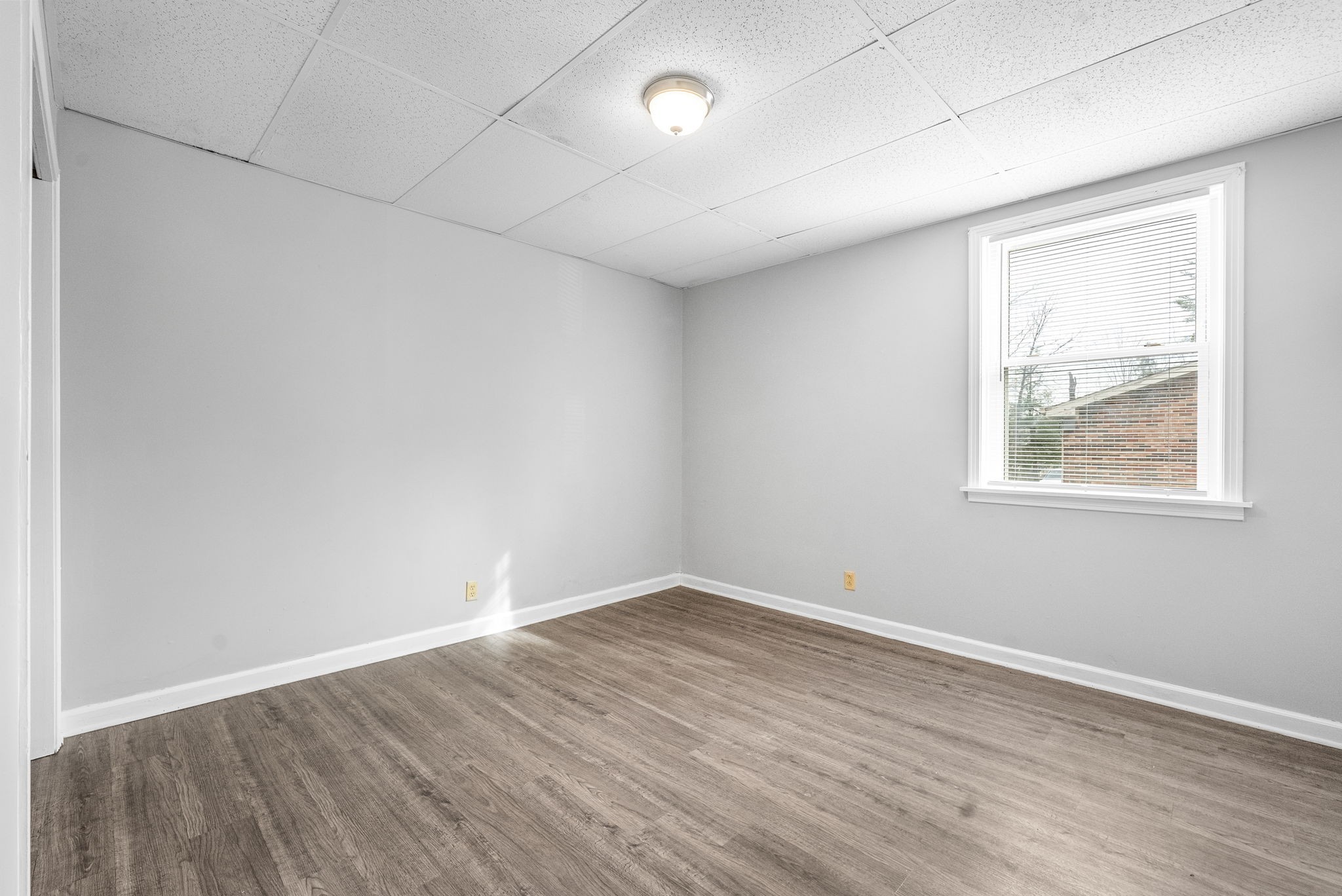 1600 Paradise Hill Road, Unit B Clarksville, TN 37043 - Photo 16 of 20 an empty room with wooden floor and windows
