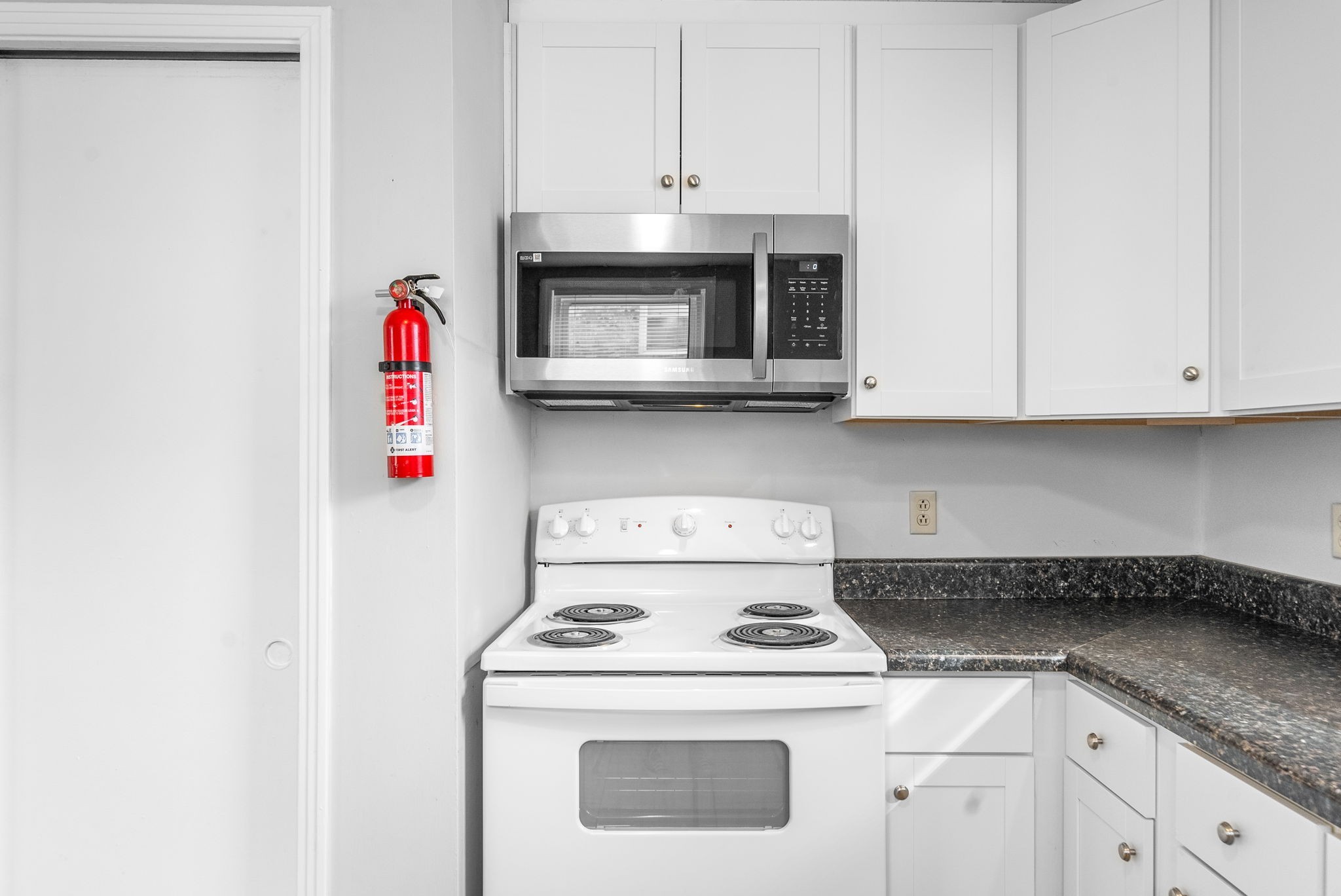 1600 Paradise Hill Road, Unit B Clarksville, TN 37043 - Photo 4 of 20 a kitchen with granite countertop white cabinets and white appliances