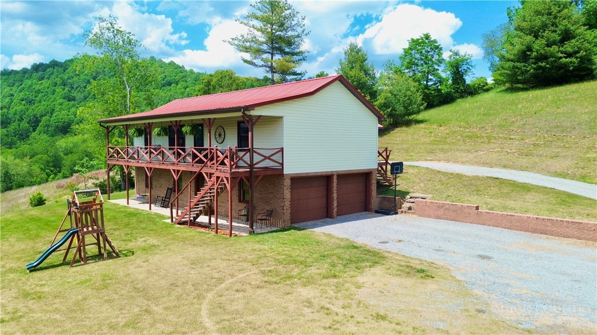 1315 Irwin Grocery Road Laurel Springs, NC 28644 - Photo 1 of 22 a view of a house with backyard porch and sitting area