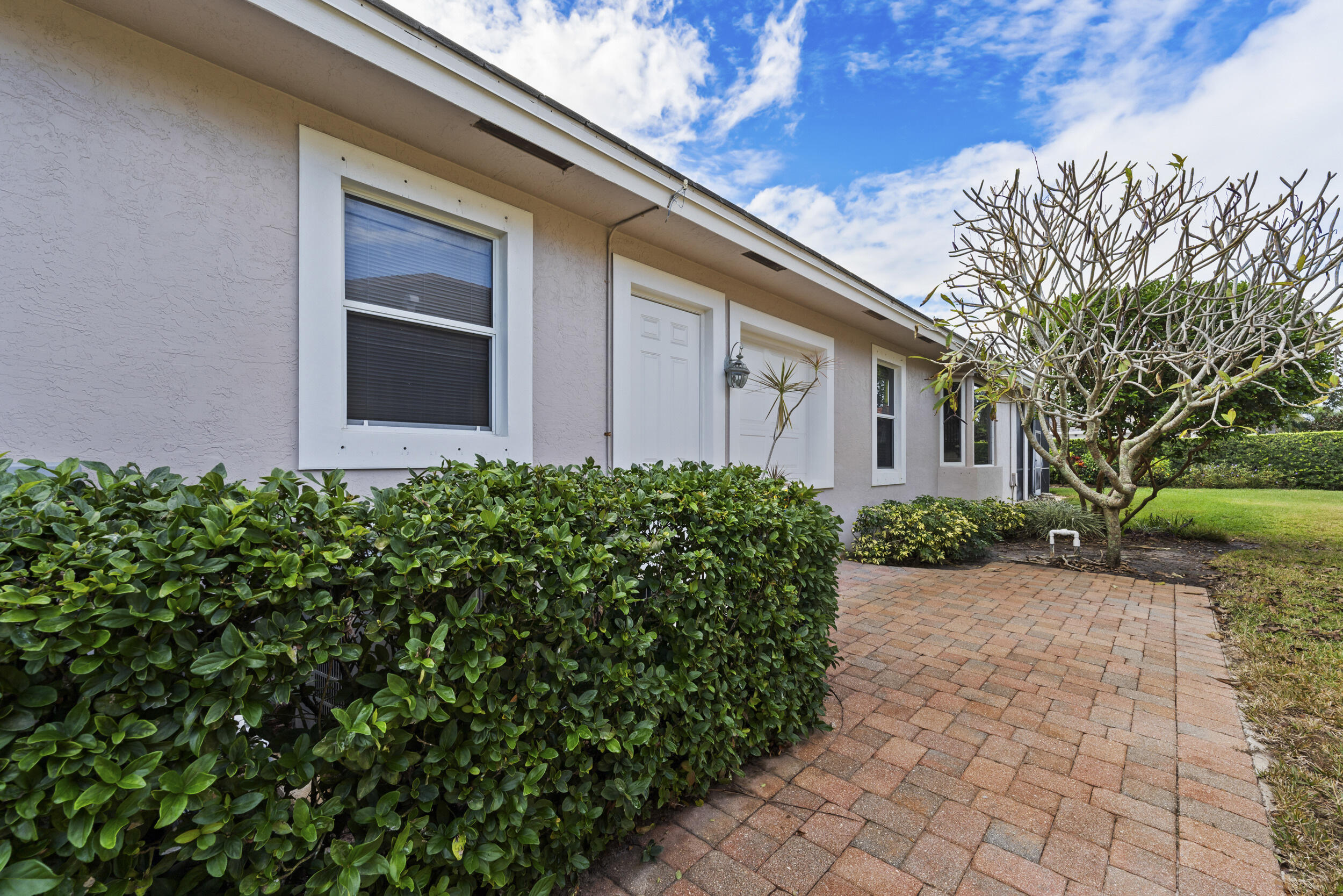 7978 Southeast Hempstead Circle Hobe Sound, FL 33455 - Photo 15 of 64 a front view of a house with garden