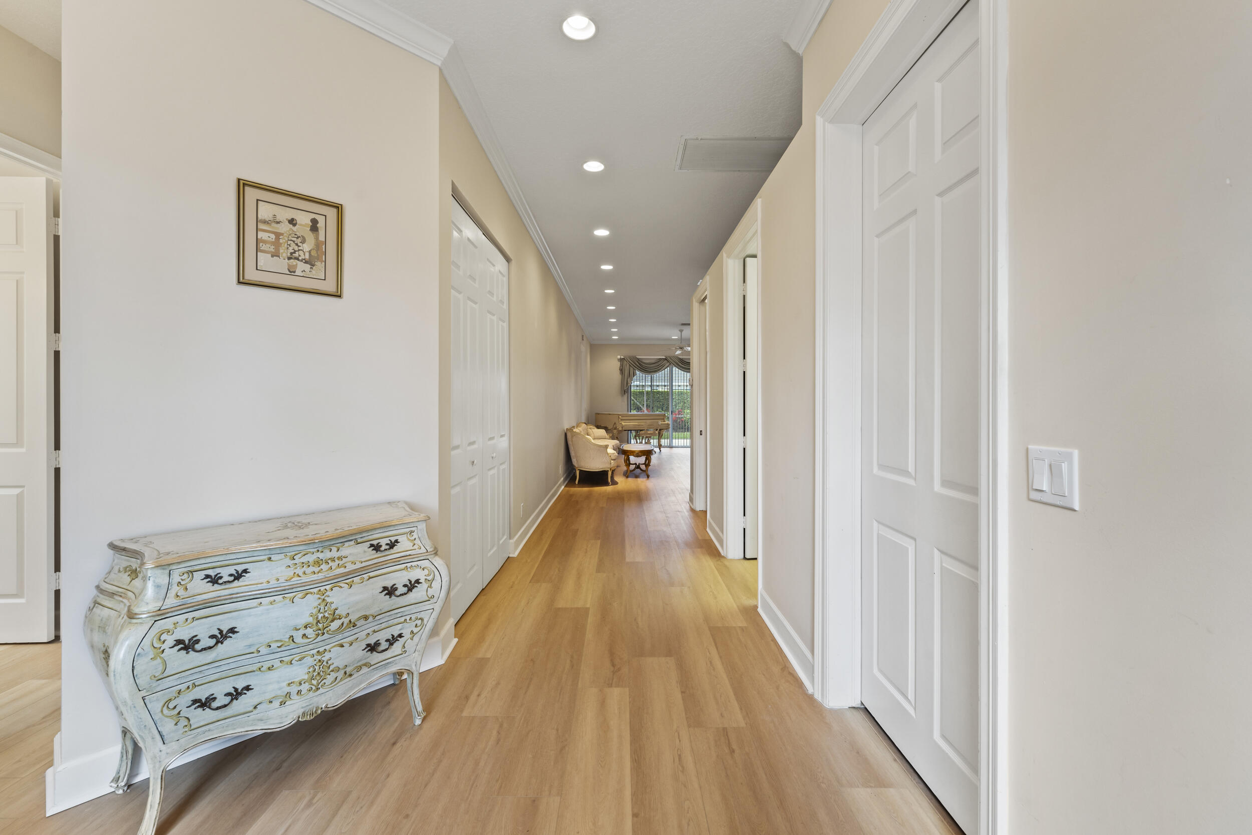 7978 Southeast Hempstead Circle Hobe Sound, FL 33455 - Photo 18 of 64 a view of a hallway with furniture and wooden floor