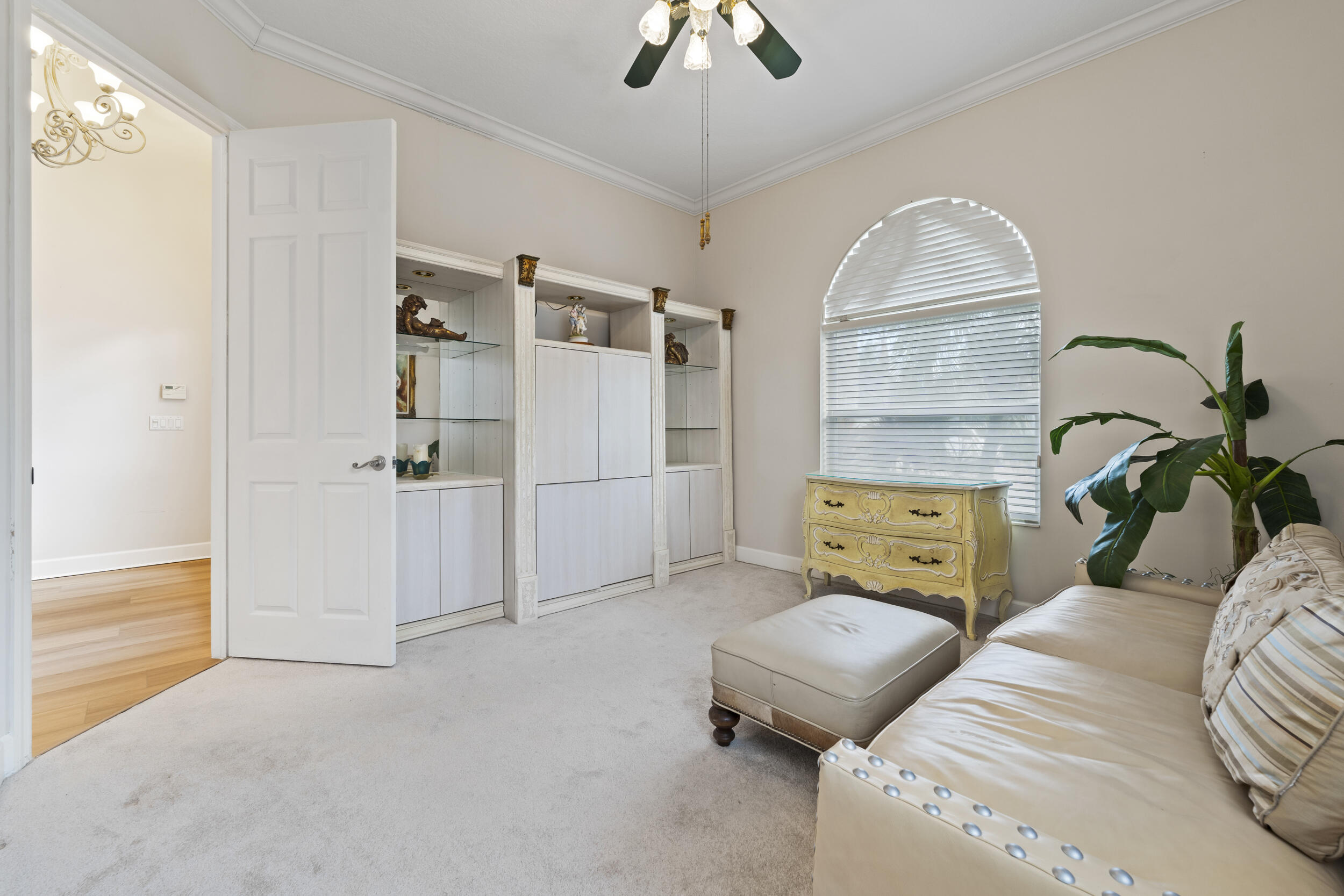 7978 Southeast Hempstead Circle Hobe Sound, FL 33455 - Photo 36 of 64 a bedroom with a bed and a chandelier