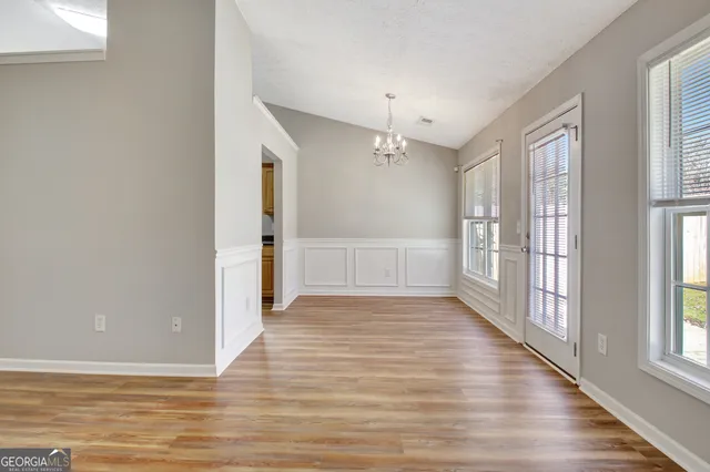 a view of a kitchen with wooden floor and a fireplace