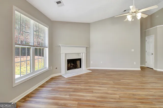 a view of wooden floor and windows in a room