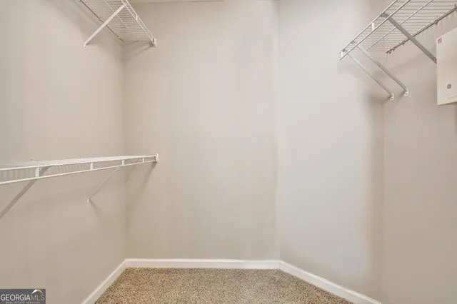 an empty room with a chandelier fan