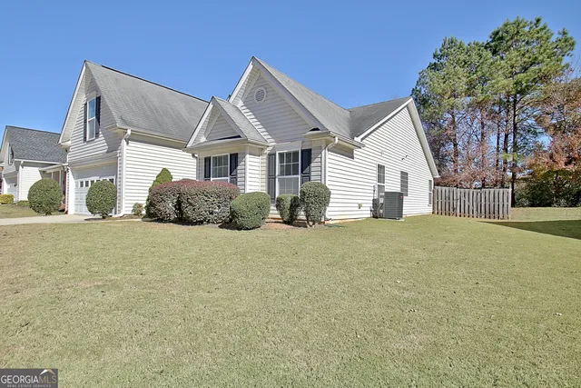 a front view of a house with a garden