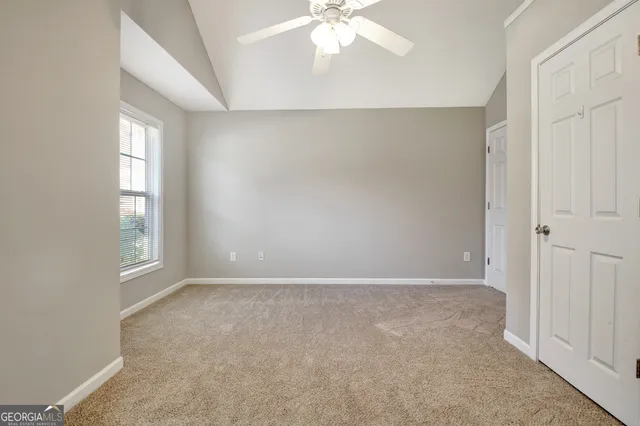 a view of a swimming pool with a garden and trees