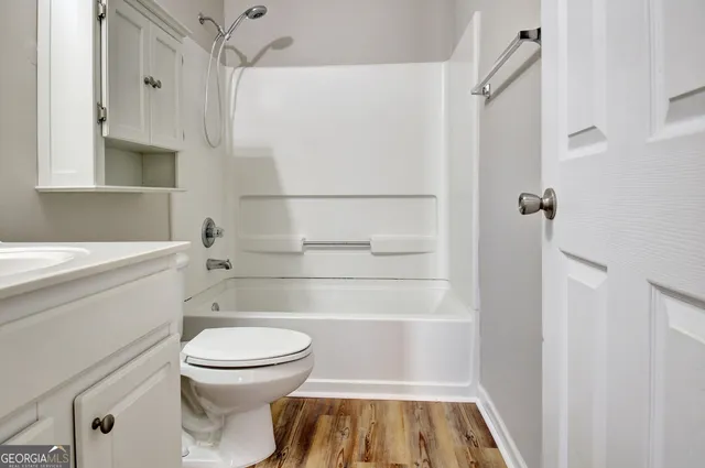 a street sign on a sidewalk next to a road