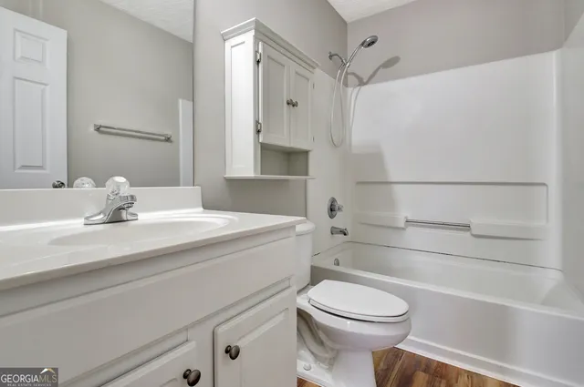 a white house with trees in the background