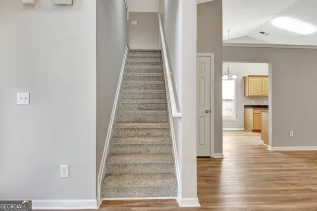 a front view of house with yard and trees in the background