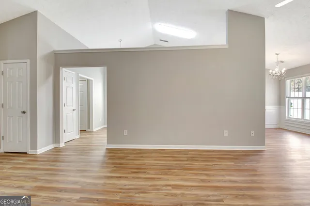 wooden floor fireplace and windows in an empty room