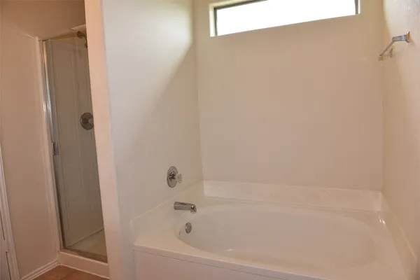 a bathroom with a glass shower door
