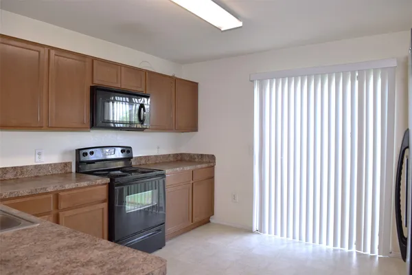 a kitchen with stainless steel appliances granite countertop a sink stove and microwave