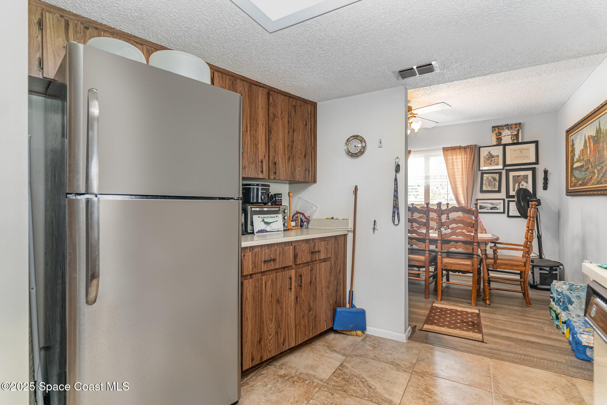 9980 Southwest 101st Lane Ocala, FL 34481 - Photo 12 of 25 a kitchen with stainless steel appliances granite countertop a refrigerator and a sink