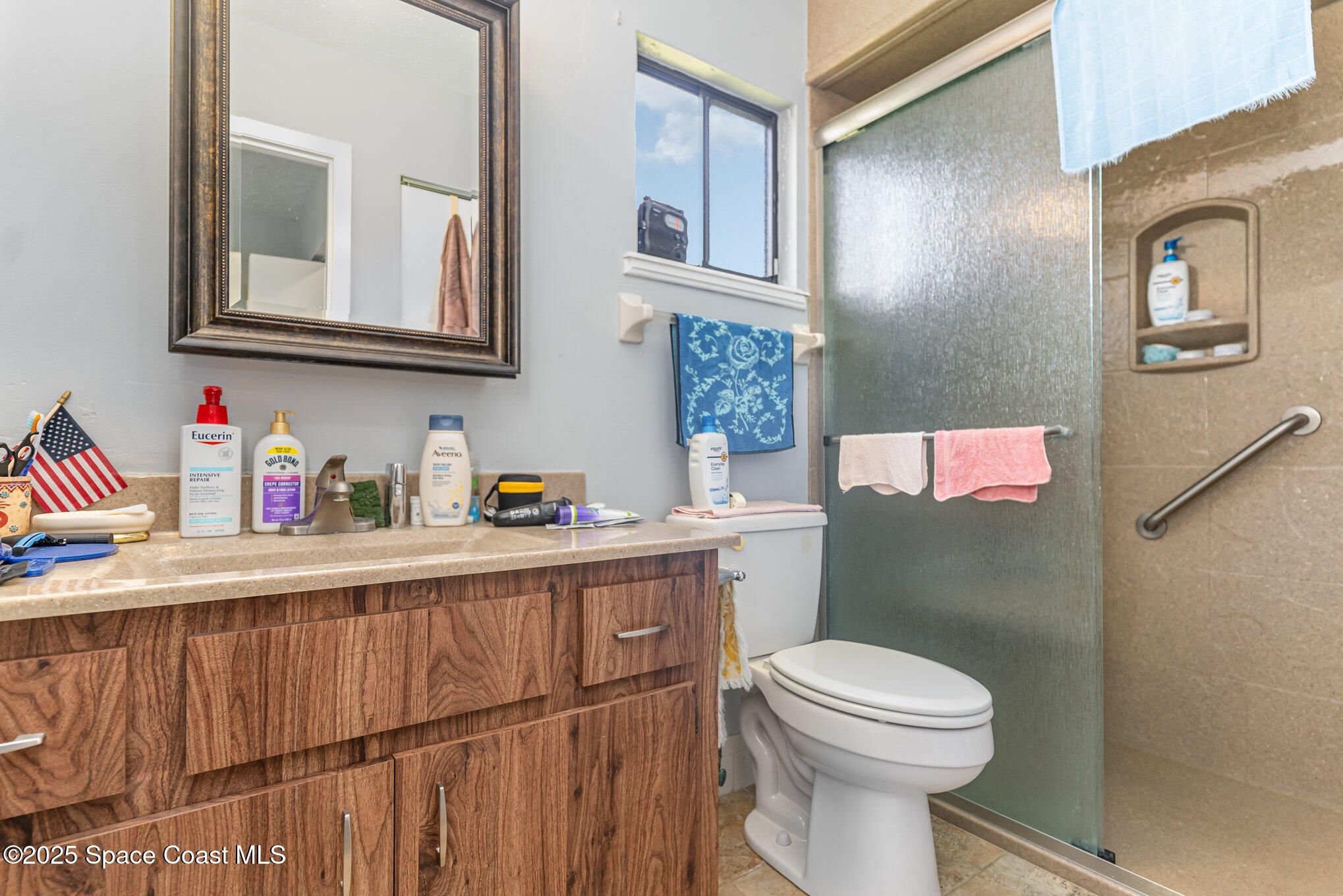 9980 Southwest 101st Lane Ocala, FL 34481 - Photo 17 of 25 a bathroom with a toilet a sink and a mirror