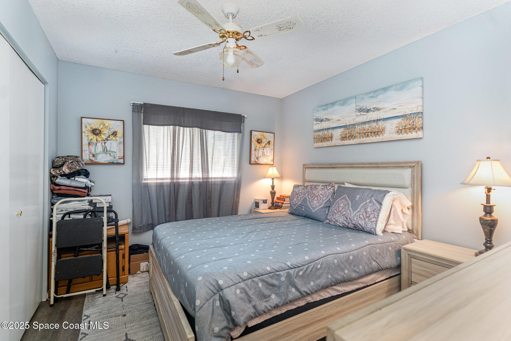 9980 Southwest 101st Lane Ocala, FL 34481 - Photo 18 of 25 a bedroom with a bed and a chandelier