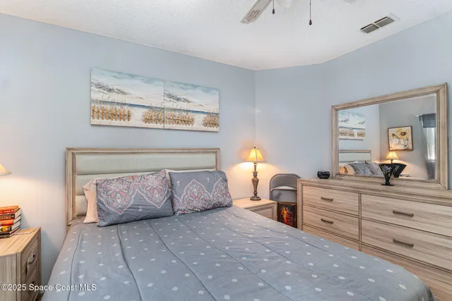 a bedroom with a bed and a dresser in it