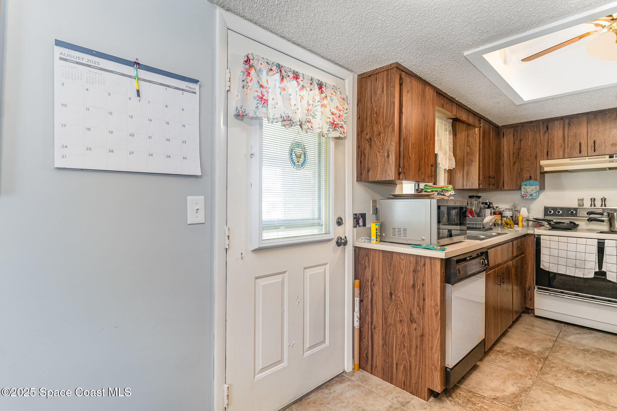 9980 Southwest 101st Lane Ocala, FL 34481 - Photo 7 of 25 a kitchen with stainless steel appliances granite countertop a refrigerator and a stove top oven