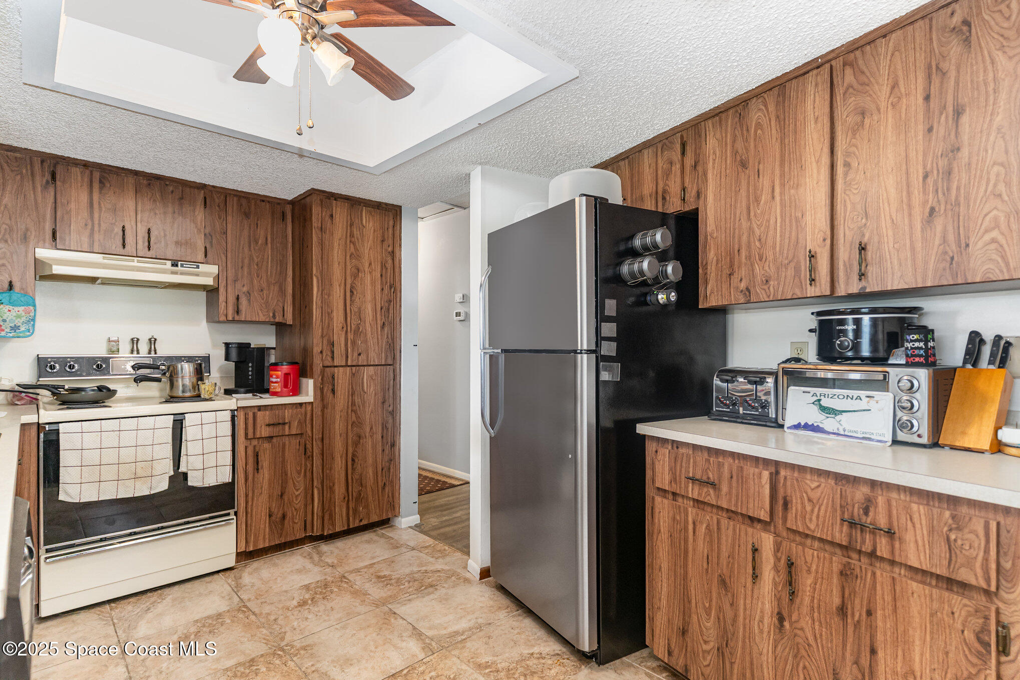 9980 Southwest 101st Lane Ocala, FL 34481 - Photo 8 of 25 a kitchen with stainless steel appliances granite countertop a refrigerator a stove a sink and dishwasher
