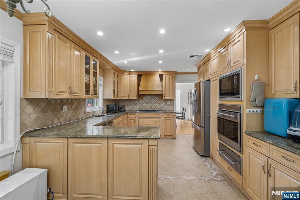 457 Summit Street Norwood, NJ 07648 - Photo 18 of 35 a kitchen with a refrigerator and a sink
