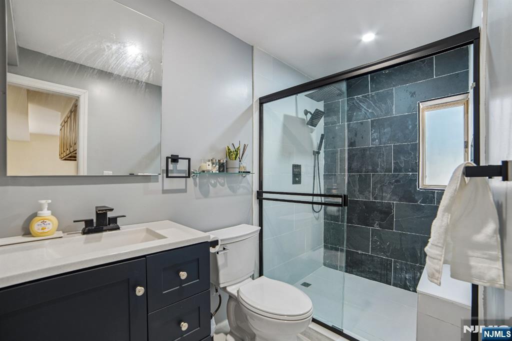 457 Summit Street Norwood, NJ 07648 - Photo 22 of 35 a bathroom with a sink a toilet and shower