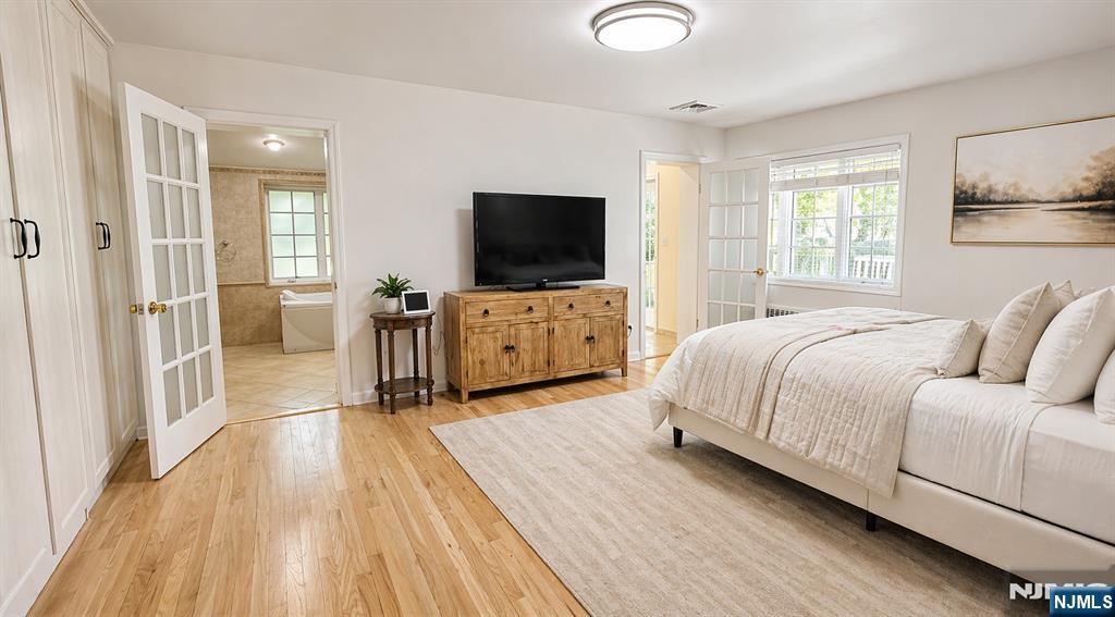 457 Summit Street Norwood, NJ 07648 - Photo 10 of 35 a spacious bedroom with a bed and a flat screen tv