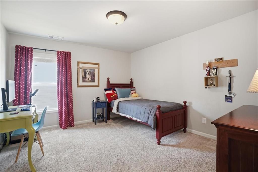 6265 Privet Way Cumming, GA 30028 - Photo 22 of 47 a bedroom with a bed and a chair