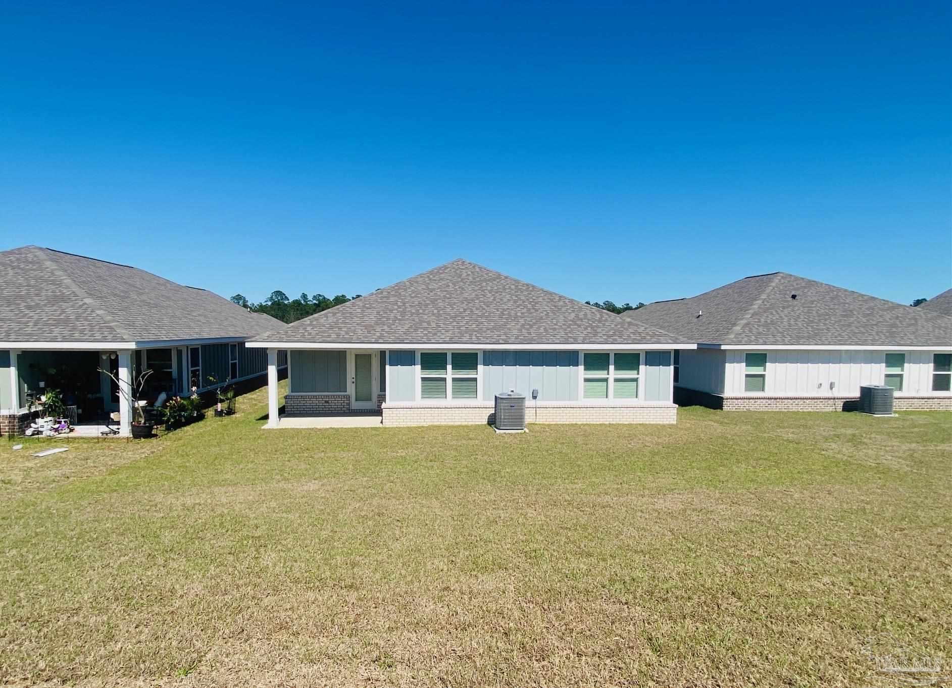 3021 Serviceberry Road Cantonment, FL 32533 - Photo 21 of 21 a front view of a house with a yard