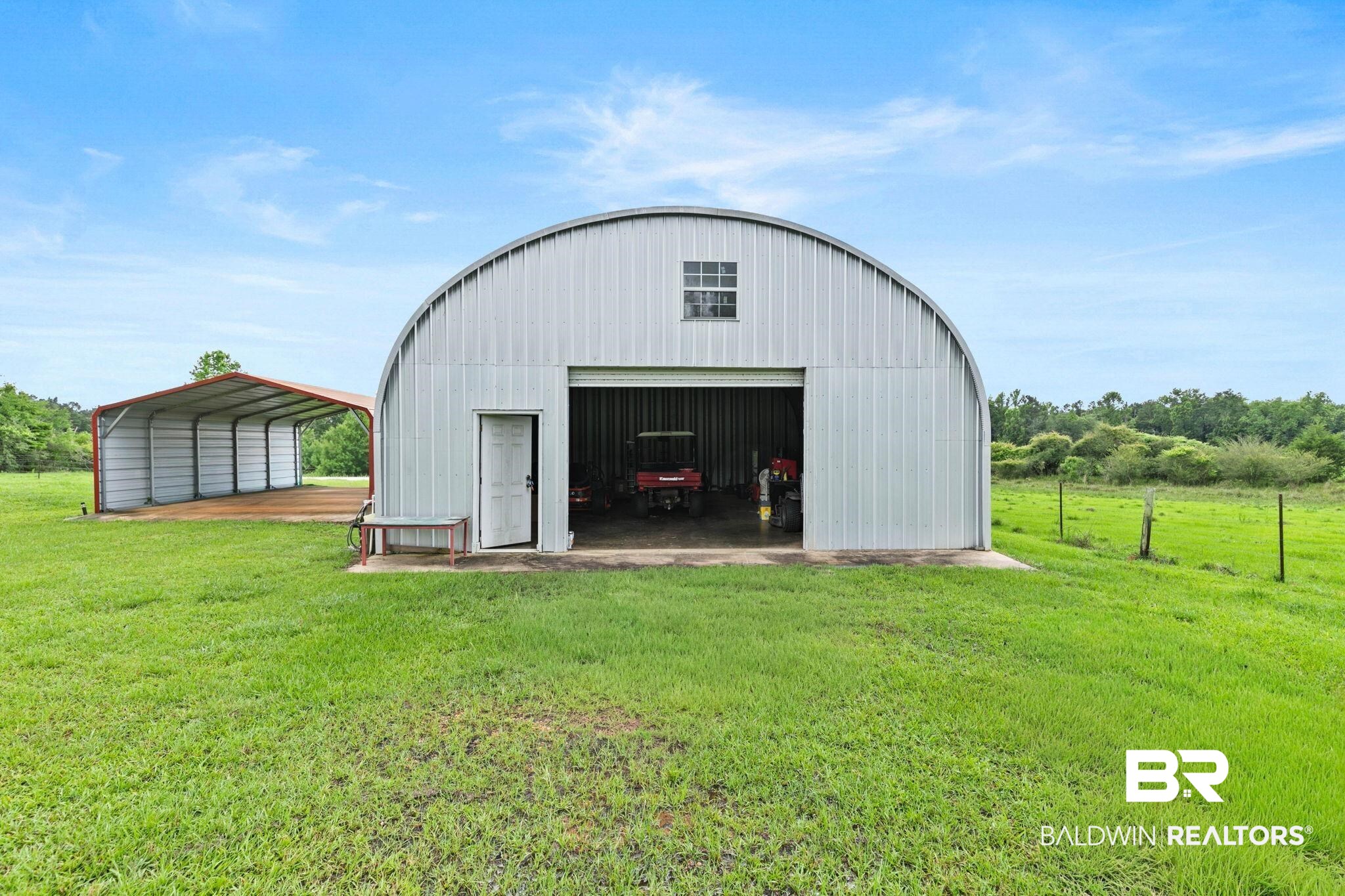 2029 George Lee Road Repton, AL 36475 - Photo 49 of 58 Metal Quonset hut structure featuring an overhead door and a side entry door