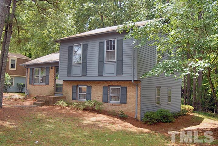 5206 Revere Road Durham, NC 27713 - Photo 3 of 22 a front view of a house with a yard and garage