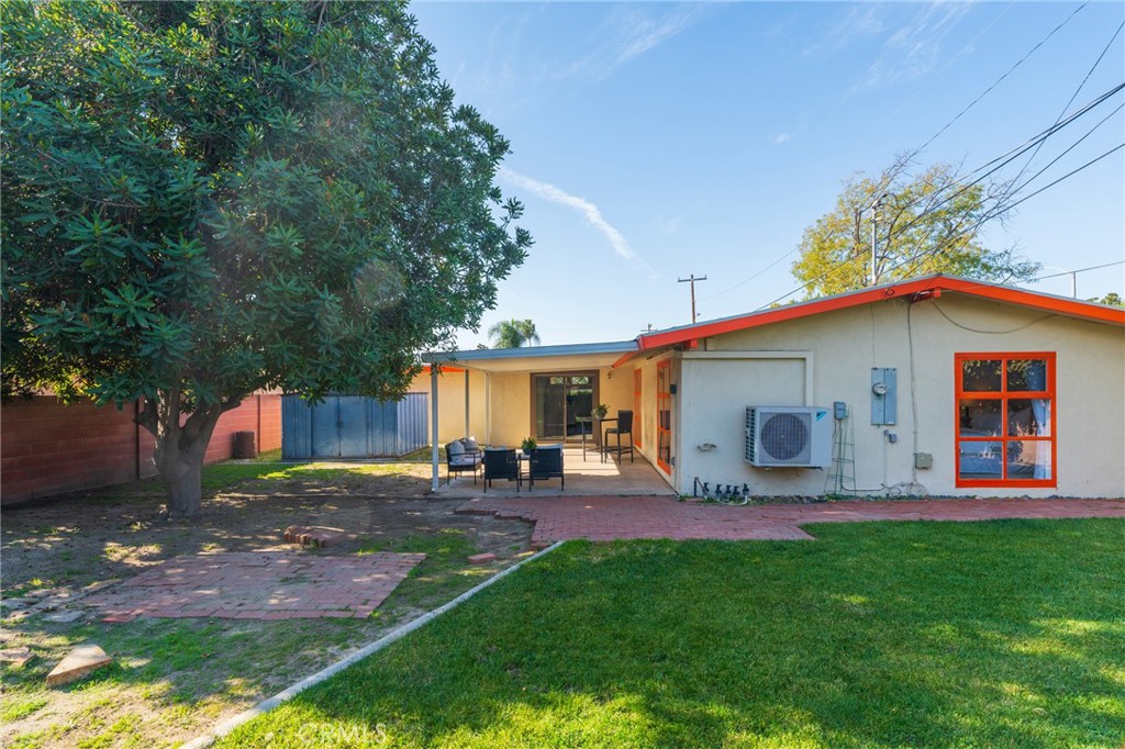 934 North Maple Street Anaheim, CA 92801 - Photo 31 of 47 a view of a backyard with table and chairs potted plants and a large tree