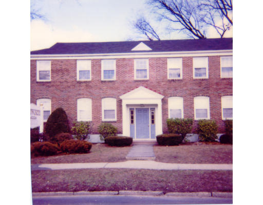 a view of a brick building with many windows
