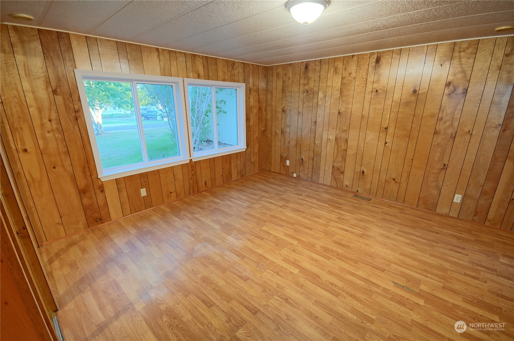 7472 Rd F Southeast, Unit 8 Othello, WA 99344 - Photo 11 of 23 a view of an empty room with wooden floor and a window