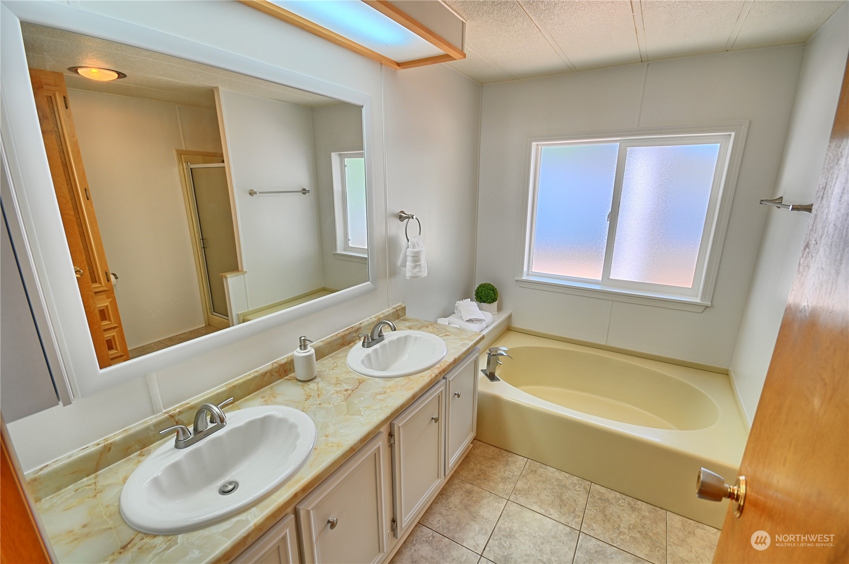 7472 Rd F Southeast, Unit 8 Othello, WA 99344 - Photo 13 of 23 a bathroom with a granite countertop tub sink and mirror