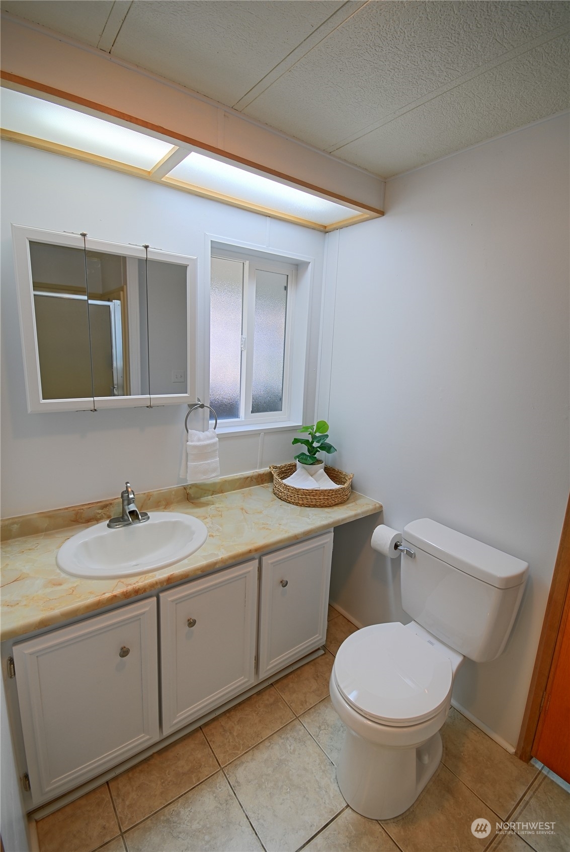 7472 Rd F Southeast, Unit 8 Othello, WA 99344 - Photo 17 of 23 a bathroom with a granite countertop toilet sink and mirror