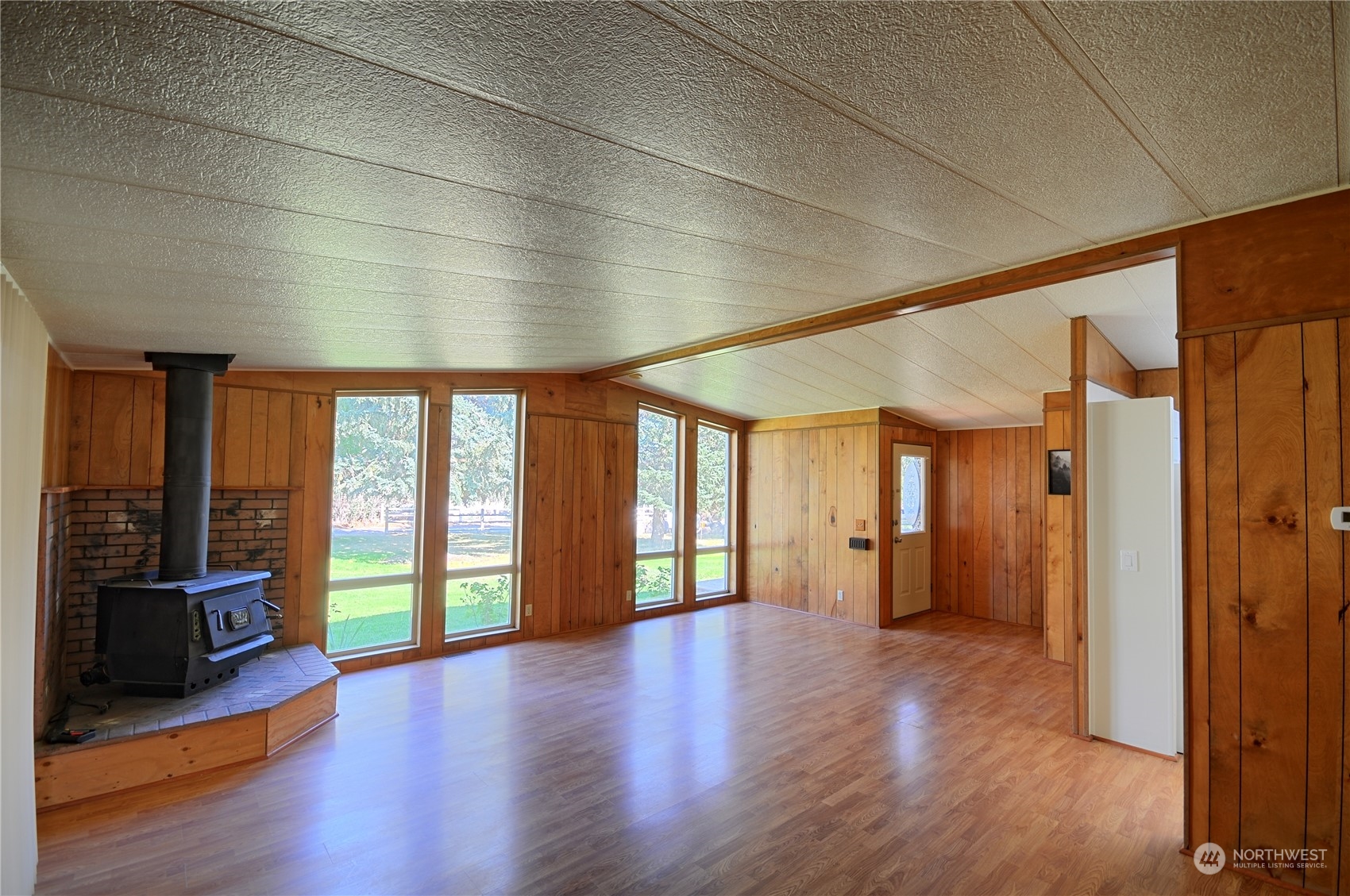 7472 Rd F Southeast, Unit 8 Othello, WA 99344 - Photo 5 of 23 a view of an empty room with wooden floor and a window